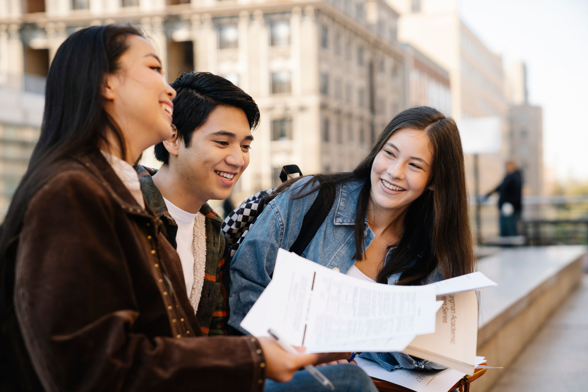 Students smiling and studying together on campus